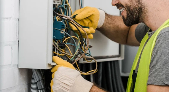 Electrician working on wiring highlighting the benefits of choosing our electrical services.