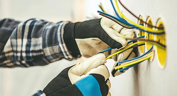 Close-up of hands working on electrical wiring for services in Silver Spring, MD.