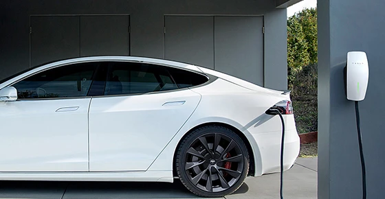 White Tesla Model 3 charging at home EV charger in Fairfax, VA. Expert installation for safe and efficient home charging.